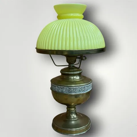 An antique brass centre-draft banquet lamp with a custard glass shade
