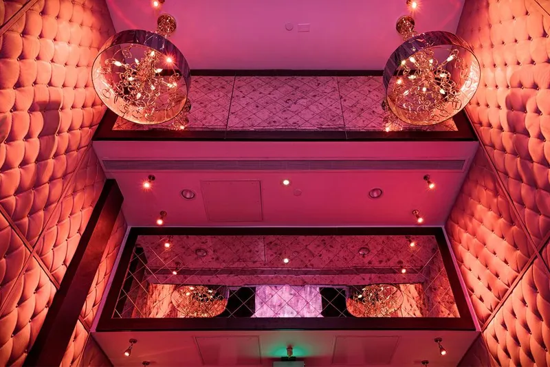 E11even Miami ultra club interior with neon stage lighting and a theatrical bar